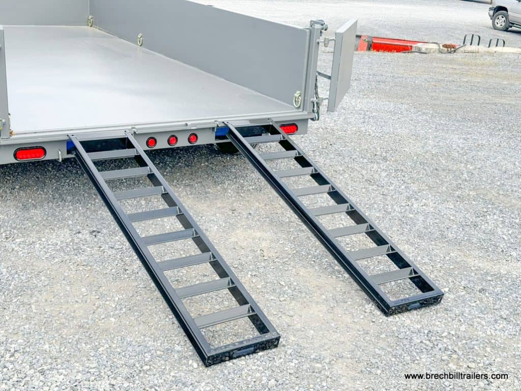 Black ramps set up on the gray dump trailer.