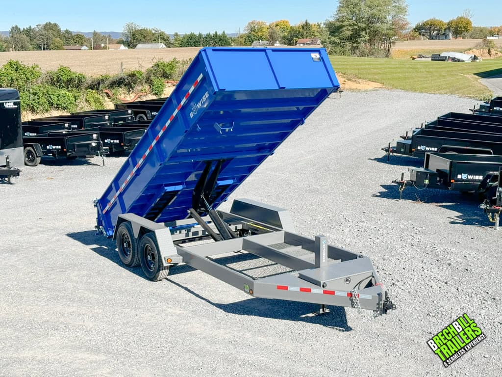 Blue Bwise DLP Heavy Duty Dump Trailer in the dump position at a Brechbill Trailers parking lot