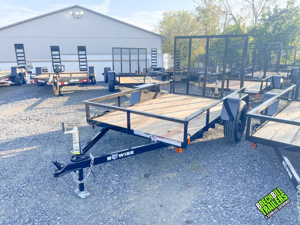 A brand new Bwise UTE 3K Utility Landscape Trailer parked at the lot.
