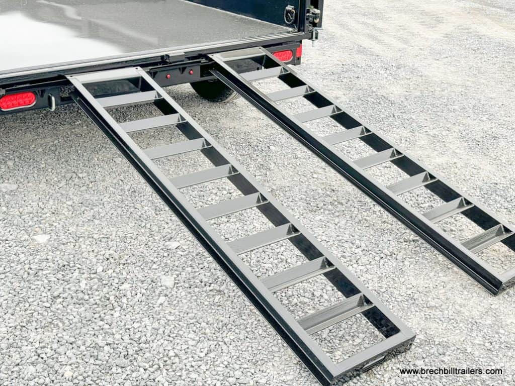 Ramps down on the trailer.