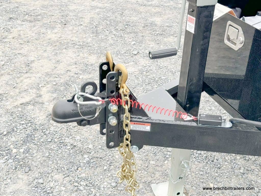The trailer's coupler, chain and jack in use while its detached.