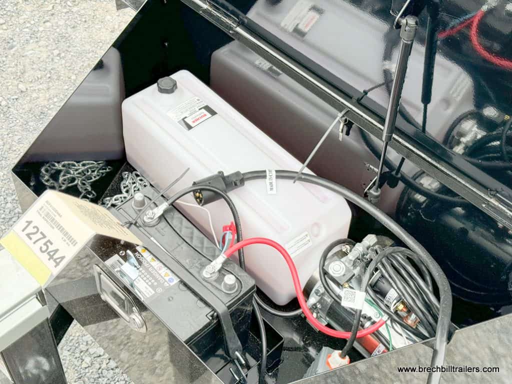 The trailer's battery and hydraulic area inside a mounted box.