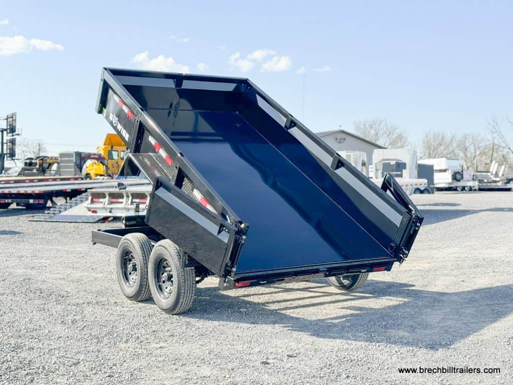 View from the back as the Bwise LP LE 12K Low Pro Dump Trailer is in the unloading position.