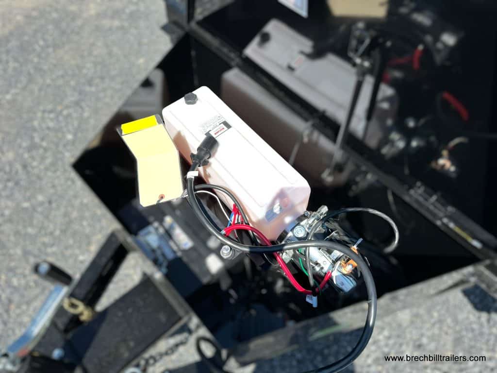 Battery and hydraulic reservoir on the trailer.