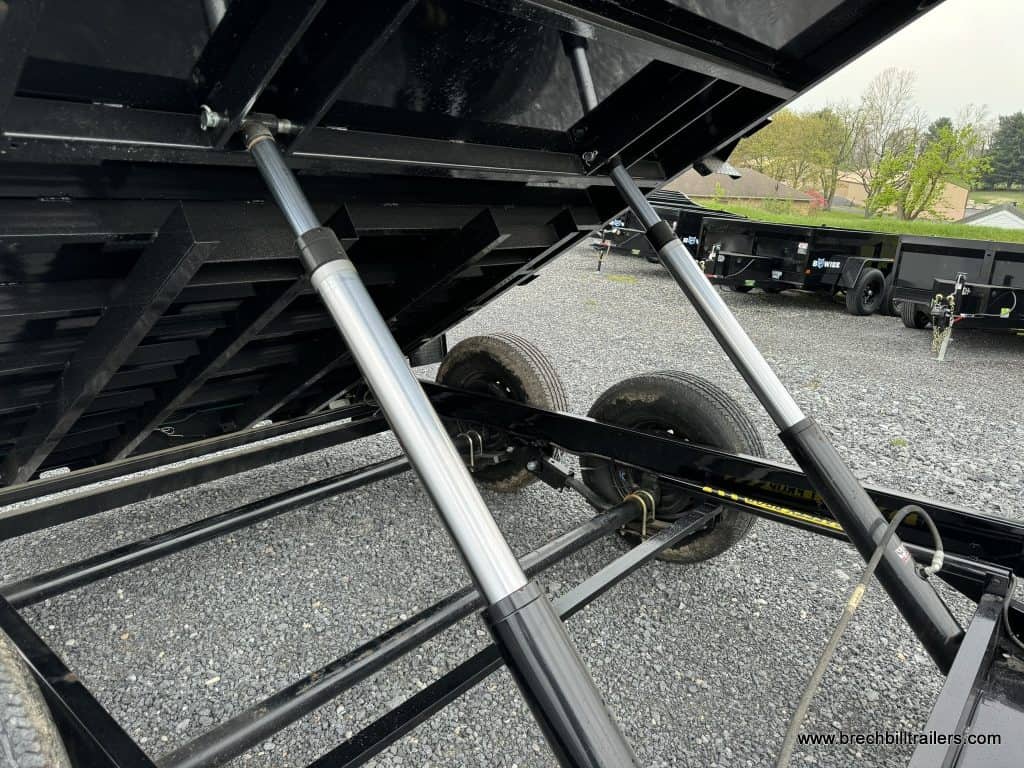 Cylinders raising the Bwise LPHD 7x12 Heavy Duty Low Pro Dump Trailer
