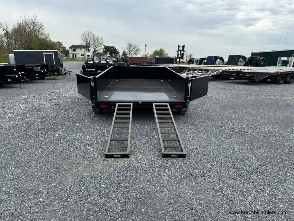 A Bwise LPHD 7x12 Heavy Duty Low Pro Dump Trailer with the ramps down.