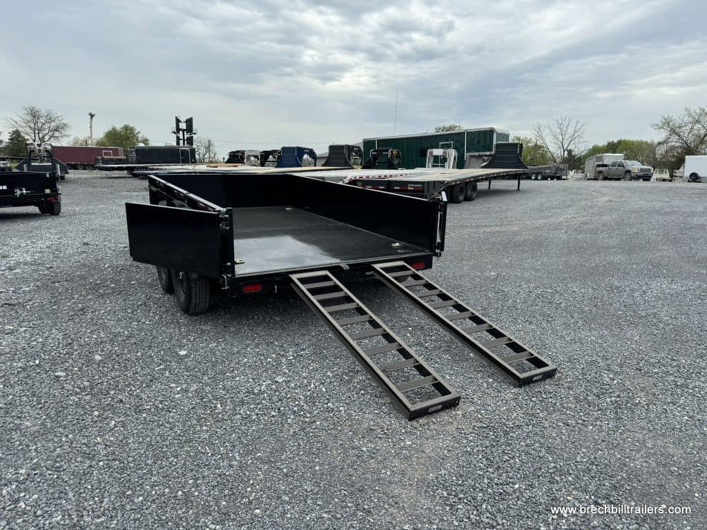 Ramps down on a Bwise LPHD 7x12 Heavy Duty Low Pro Dump Trailer