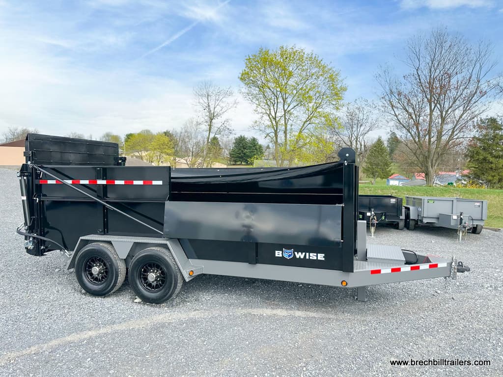 Brand new Bwise DU Ultimate Dump Trailer with black wheels.
