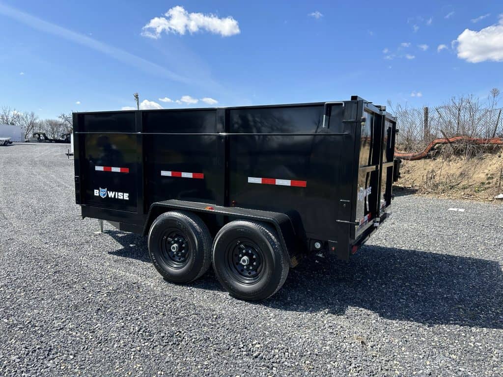 A new black Bwise dump trailer with black wheels.