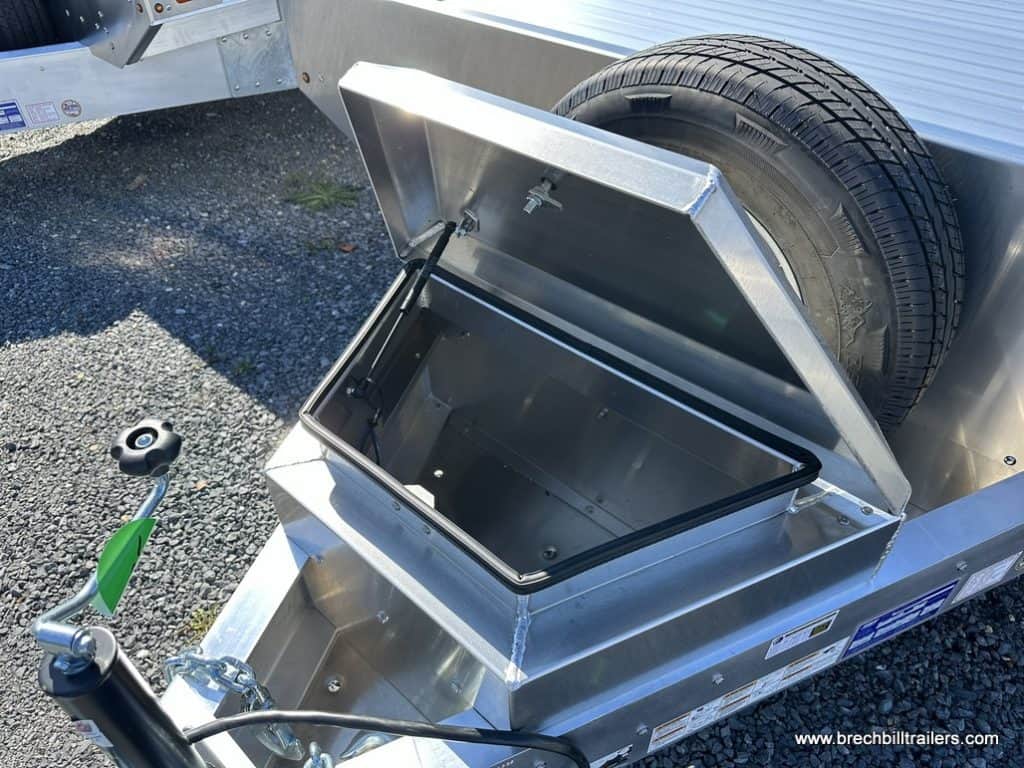 Storage box on front of trailer with mounted spare tire.