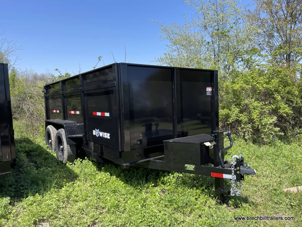 A black Bwise LPHD Low Pro Dump Trailer parked in the yard