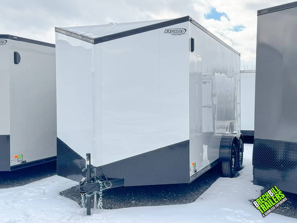 Bravo 7K Enclosed Box Trailer parked at the dealership next to a line of other Bravo enclosed trailers