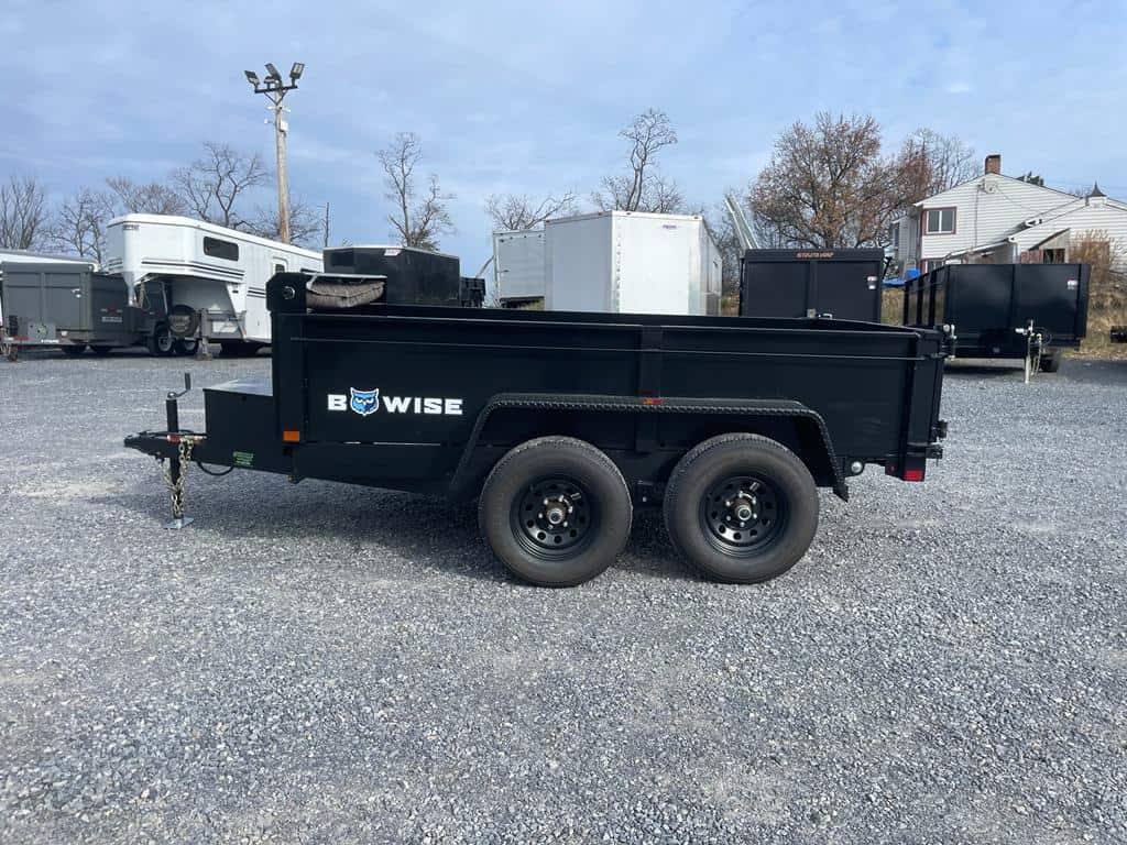 The side of Bwise LP LE Low Pro Dump Trailer in the Brechbill Trailers lot