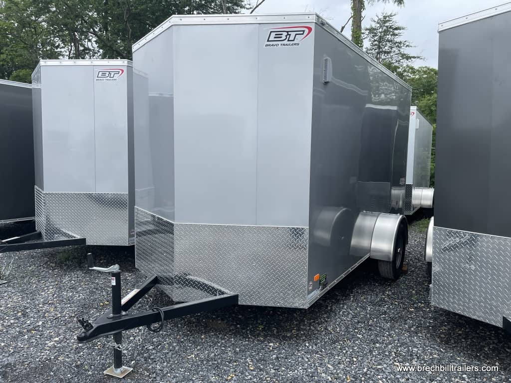 Front of a new Bravo Scout Enclosed Cargo Trailer parked in the yard