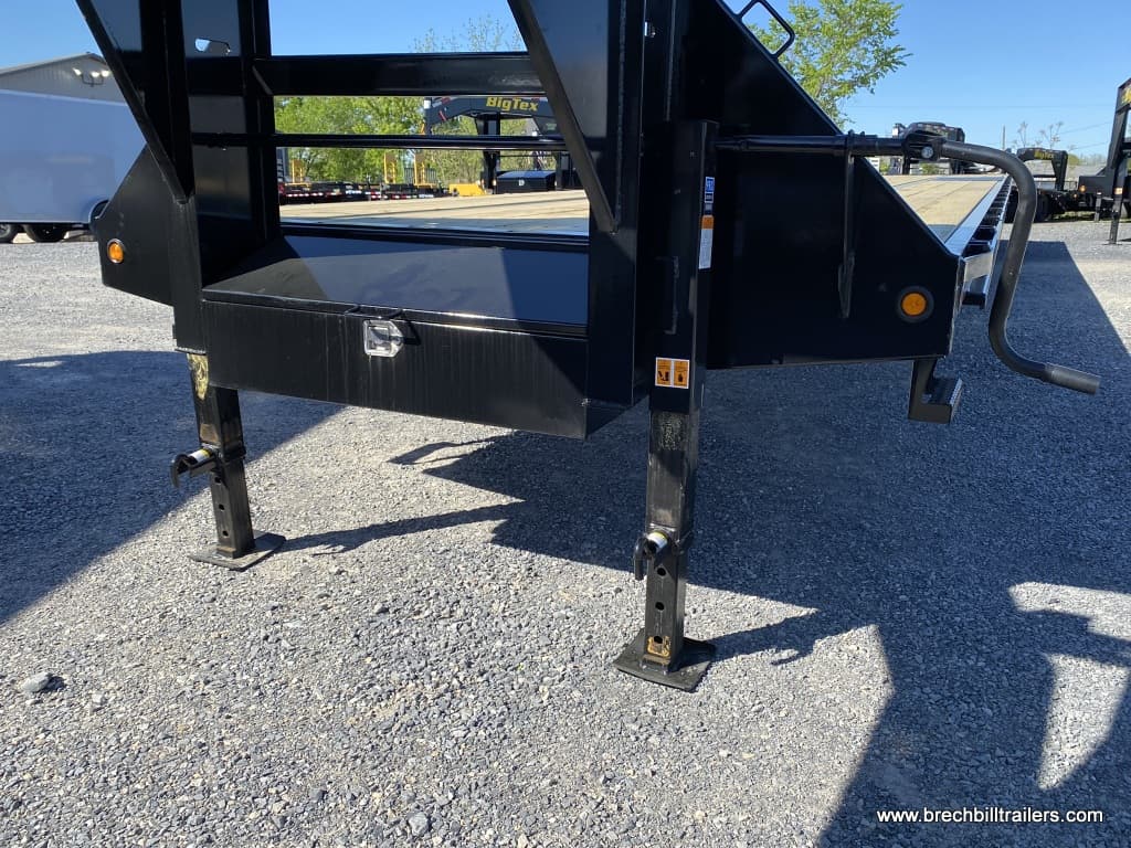 Big Tex Tandem Dual Wheel Gooseneck Trailer pakred with its dual jacks.