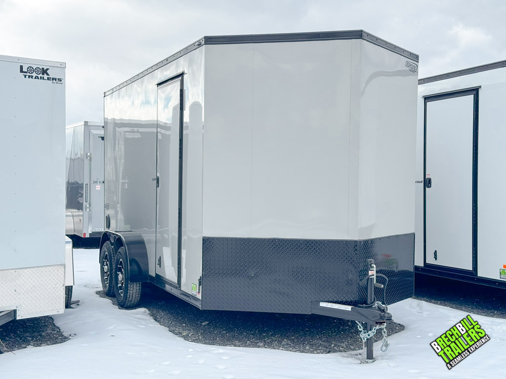 A white Bravo Scout Enclosed Cargo Trailer