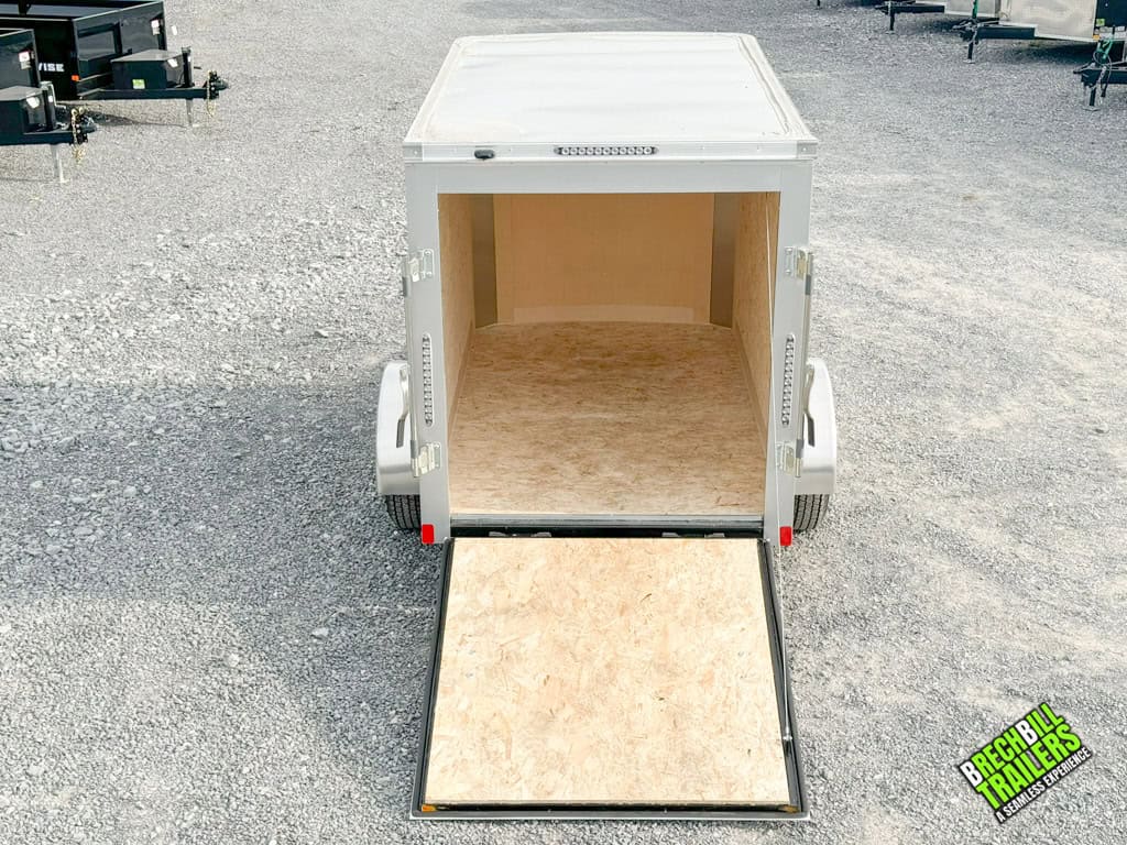 Top down view of a new Bravo Hero Enclosed Cargo Trailer with the ramp down so you can see inside.