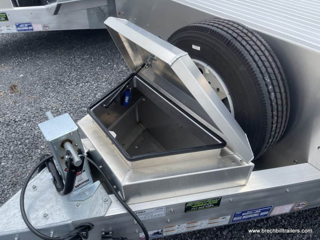 Looking at the front toolbox next to the spare tire.