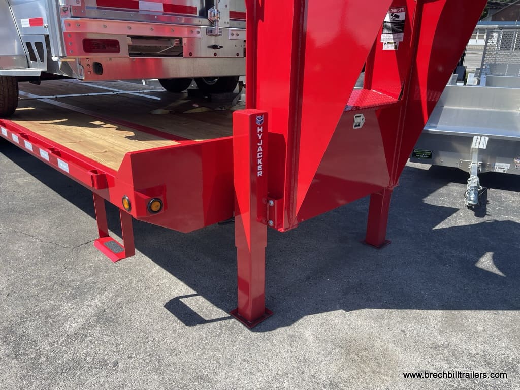 Red gooseneck trailer parked