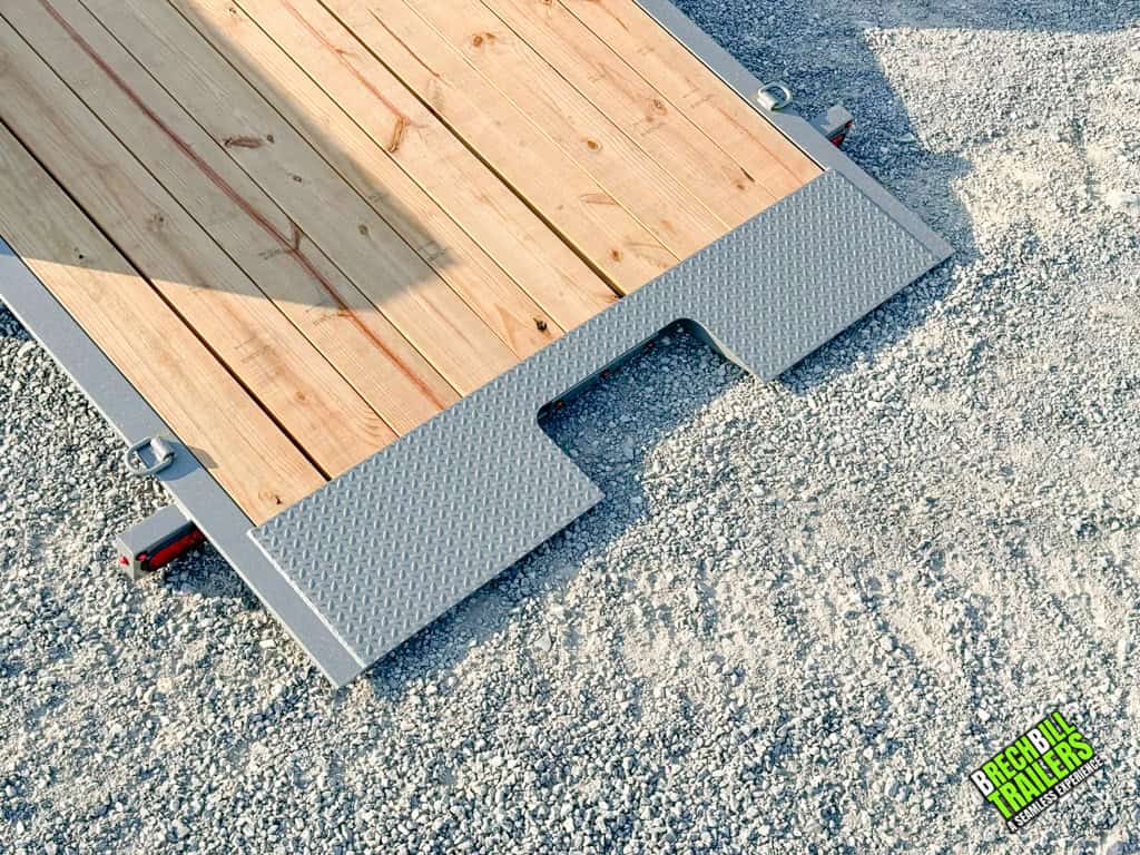 Gray tilt trailer all the way down to the ground.