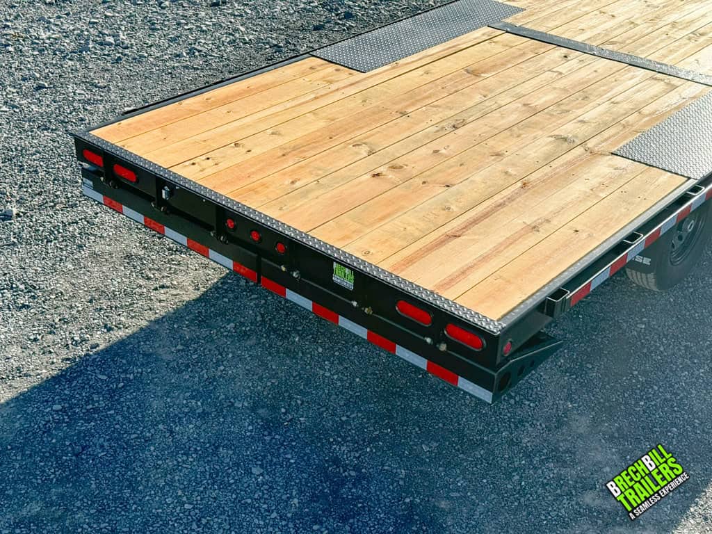 Heavy duty wood deck on a Bwise THD22-15 hydraulic tilt-deck trailer.