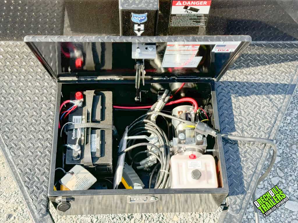 The THD26-17 trailer's battery box with hydraulic line and power line.
