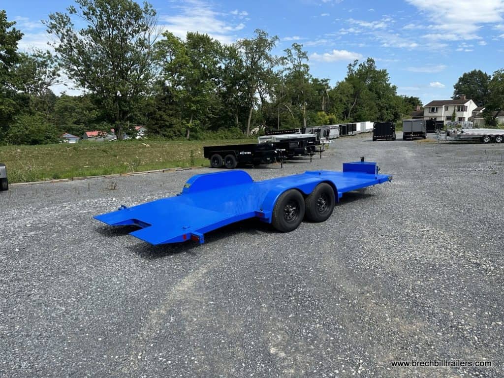 A brand new Bwise CHT 10K Car-Hauler Hydraulic Tilt trailer parked in the yard.