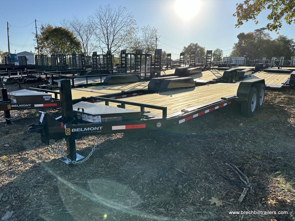 Belmont Low Pro Gravity Tilt Skid Steer Equipment Trailer parked in the yard with other Belmont trailers