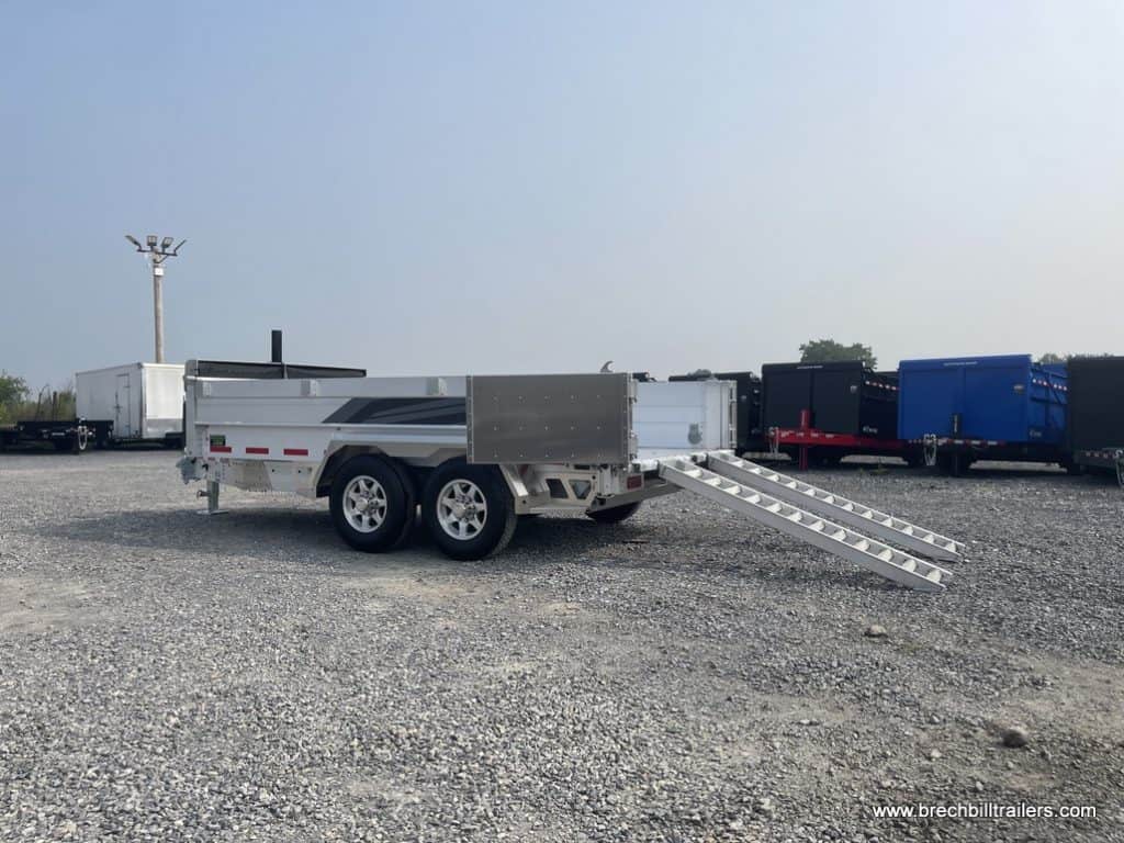 Side view of a EBY All Aluminum Bumper Pull Dump Trailer with the ramps down.