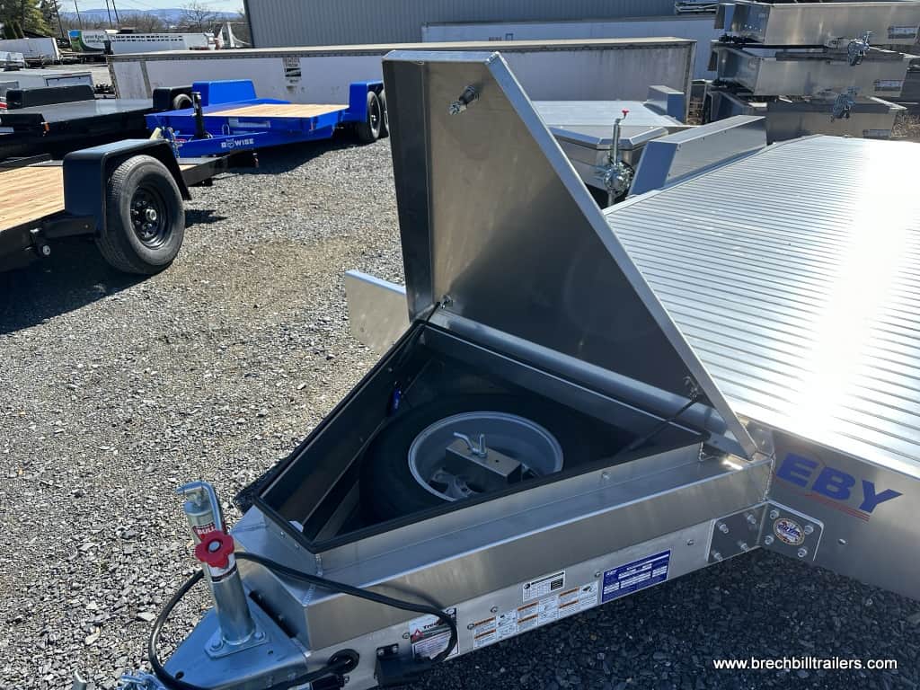 Toolbox open with storage space and a space tire