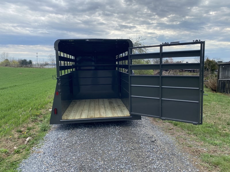 Swing door on the charcoal Valley 7K Steel Livestock Trailer 7x16