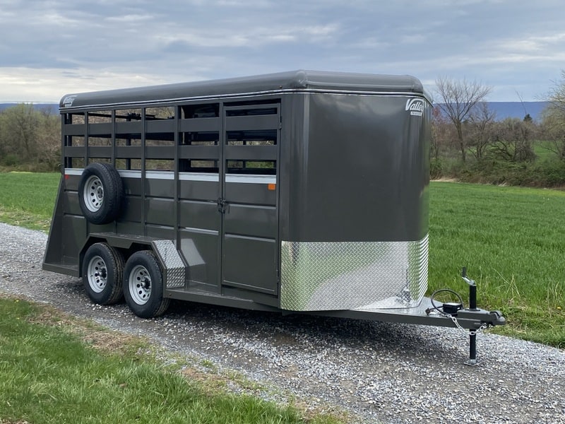 A Valley 7K Steel Livestock Trailer parked on a gravel road.