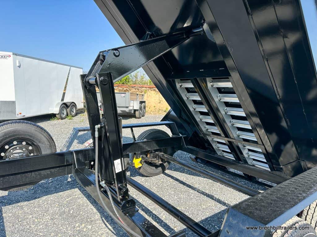 Hydraulic cylinder extended to dump trailer load.