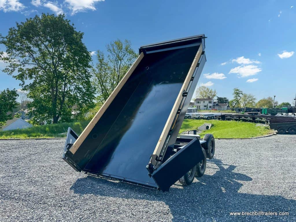 A 7x14 Southland 16K Tandem Axle Dump Trailer in the dump position in the lot.