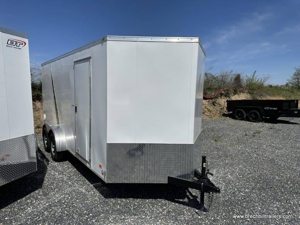 A brand new white Bravo Scout 7K Enclosed Cargo Trailer
