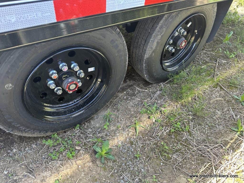 Black wheels on the Bwise 19K THD Hydraulic Tilt-Deck Gooseneck Trailer