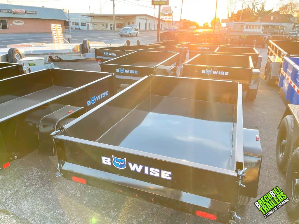 A bunch of Bwise dump trailers for sale at the Brechbill Trailers lot