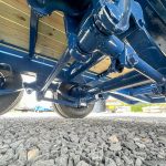 All blue frame shown from under the Belmont 26K Heavy Duty Gooseneck Trailer