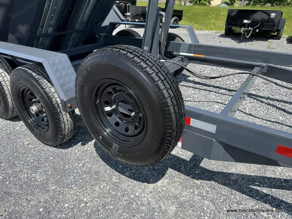Spare tire mounted on the side of the trailer frame.