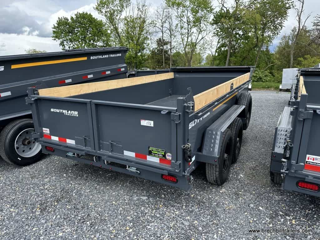 A 7x14 charcoal gray Southland 16K Tandem Axle Dump Trailer parked in the lot for sale.