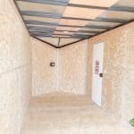 The interior of a Bravo Scout 7K Enclosed Cargo Trailer with lighting