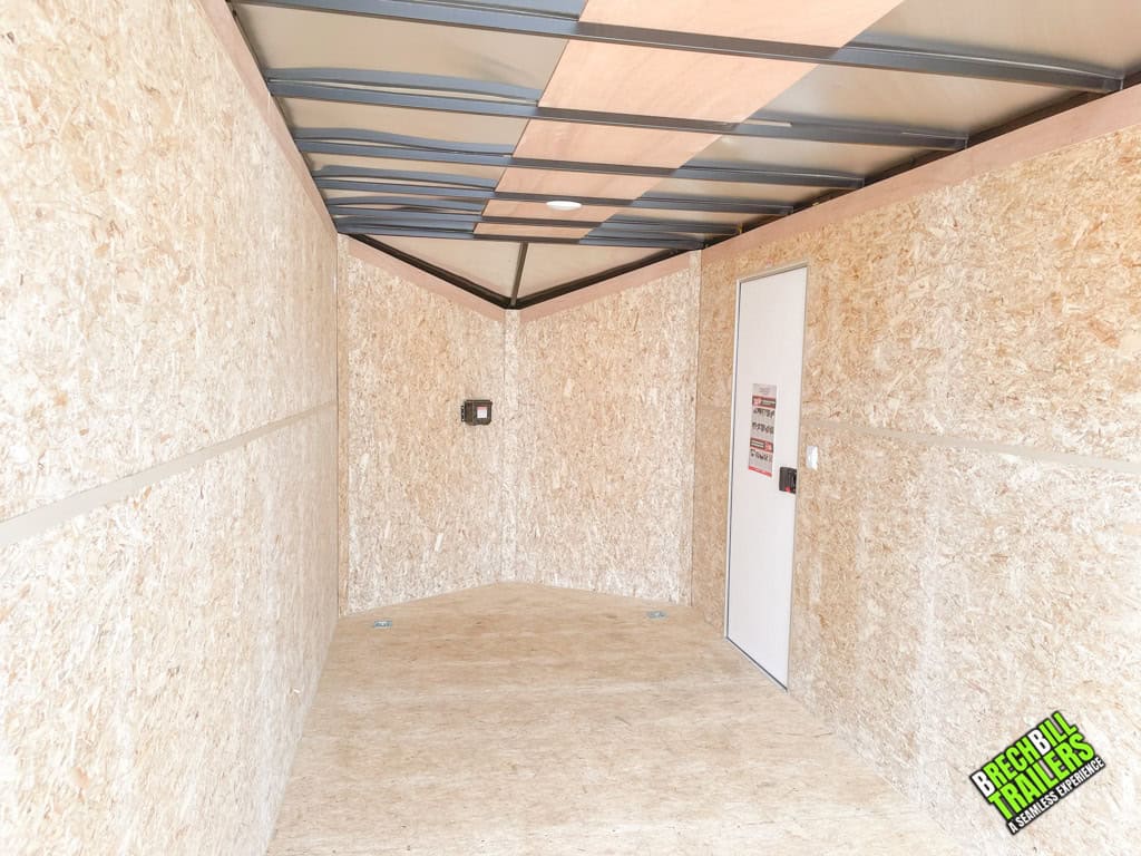 The interior of a Bravo Scout 7K Enclosed Cargo Trailer with lighting