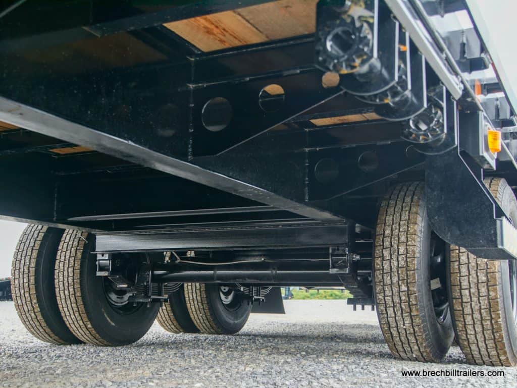 Under a Southland dual axle gooseneck trailer.