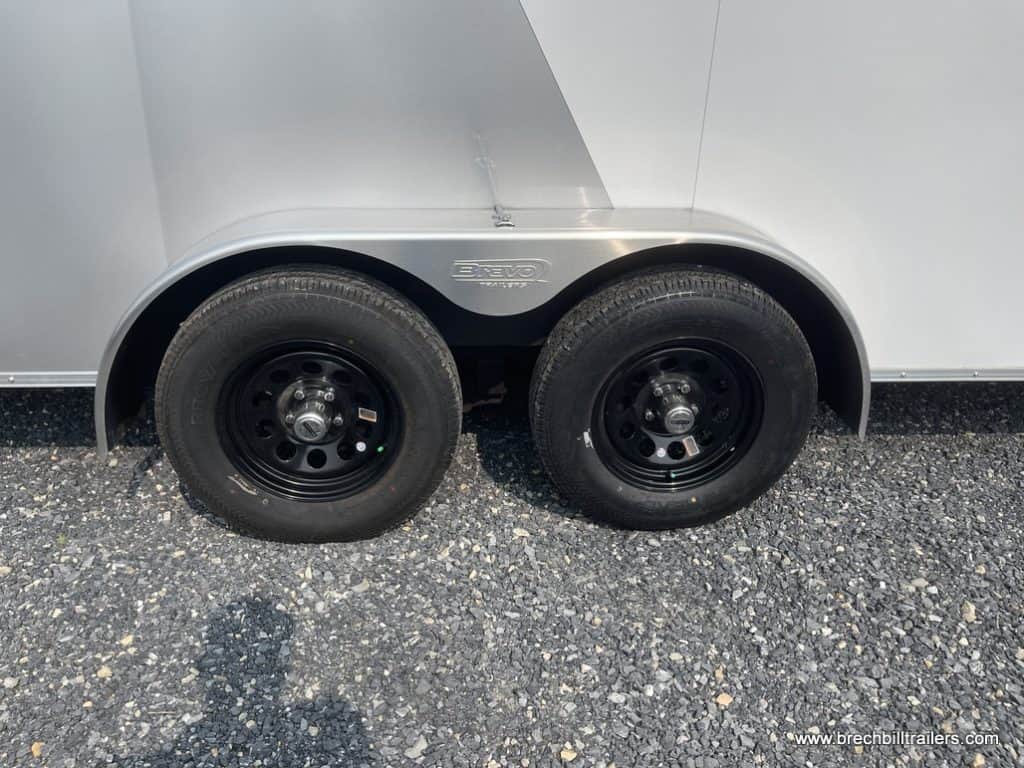 Black wheels on the white and silver cargo trailer.