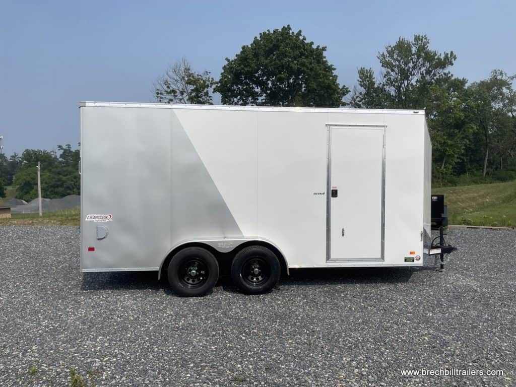 Side of a brand new white and silver Bravo enclosed cargo trailer for sale.