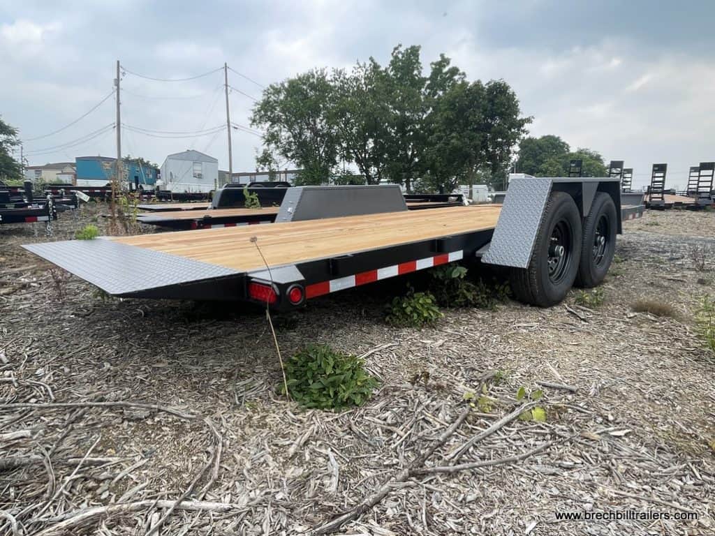Bwise 15K Low Pro Gravity Tilt Deck Trailer with a ramp on the back.