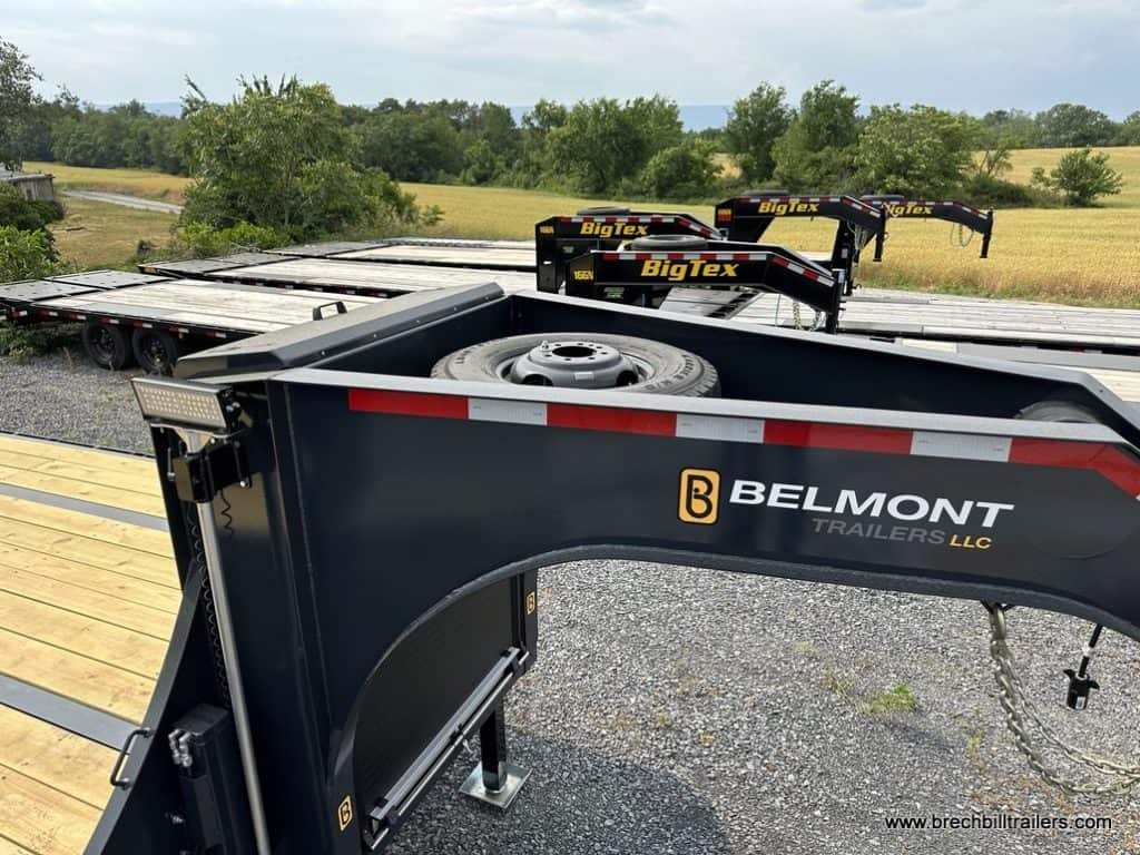 A spare wheel mounted on top of a gooseneck trailer.