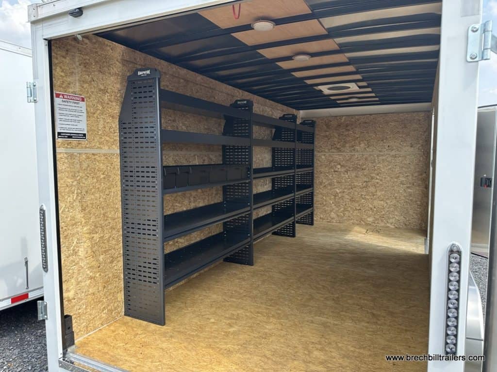 Interior of trailer with shelving for storage and tools.