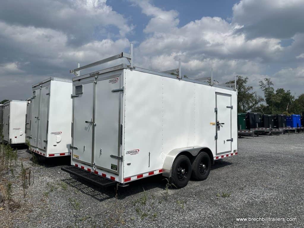 A white Bravo 10k Tradesmen enclosed cargo trailer.