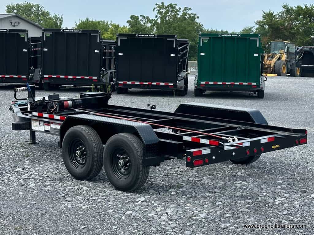 Brand new Big Tex 14K Roll Off Bumper Pull Dump Trailer parked in the lot.